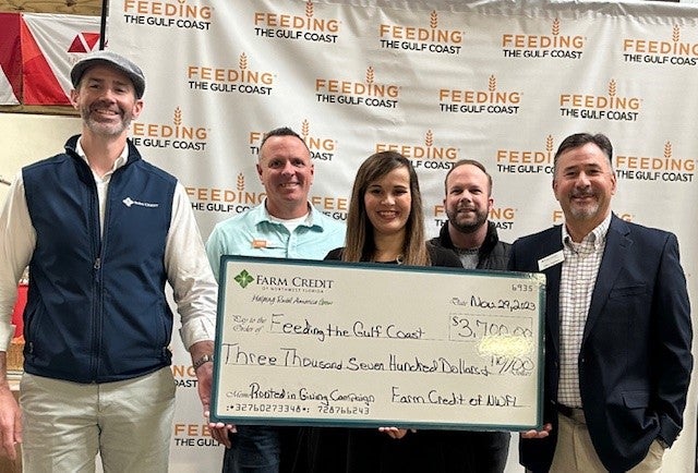 Rooted in Giving Donation Award to Andrew Brantley, VP of Finance and Anna Goretski, Community Engagement Coordinator of Feeding the Gulf Coast by John Gregory, Farm Credit of Northwest Florida, CEO