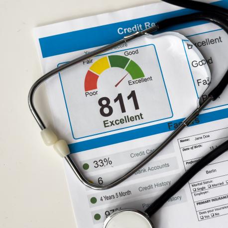 Stethoscope resting on a credit report, illustrating a financial checkup.